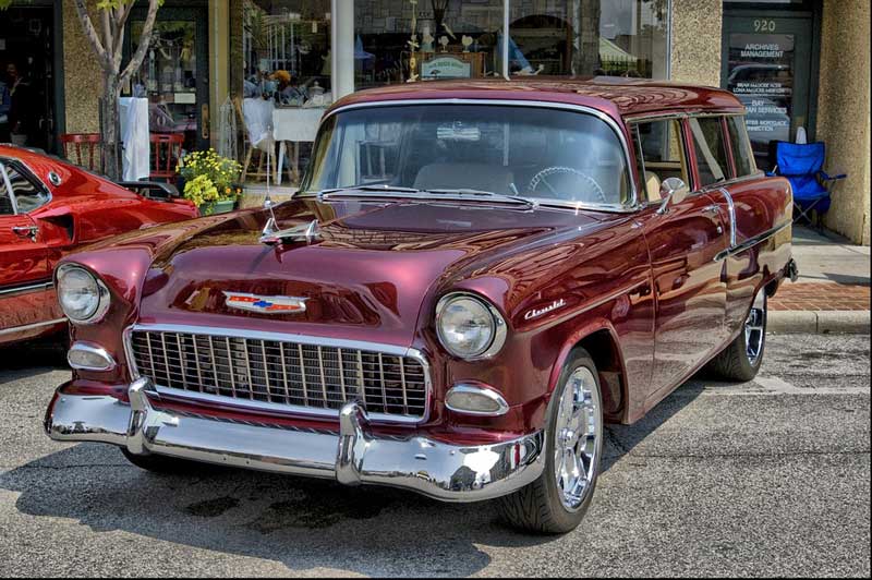 A maroon classic Chevy-style station wagon parked on a street.