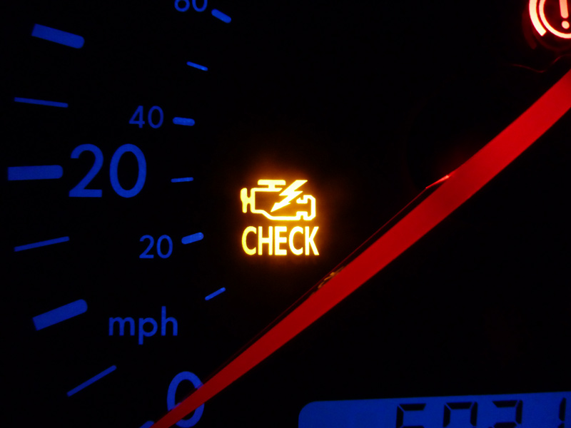 Check-engine light on car dashboard.