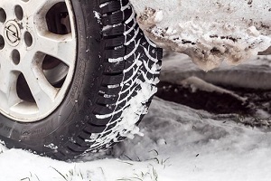Close-up of a car tire with snow on tread