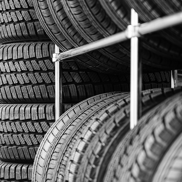 Rack with variety of new car tires in automobile store