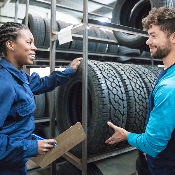Customer choosing car tire in automobile store
