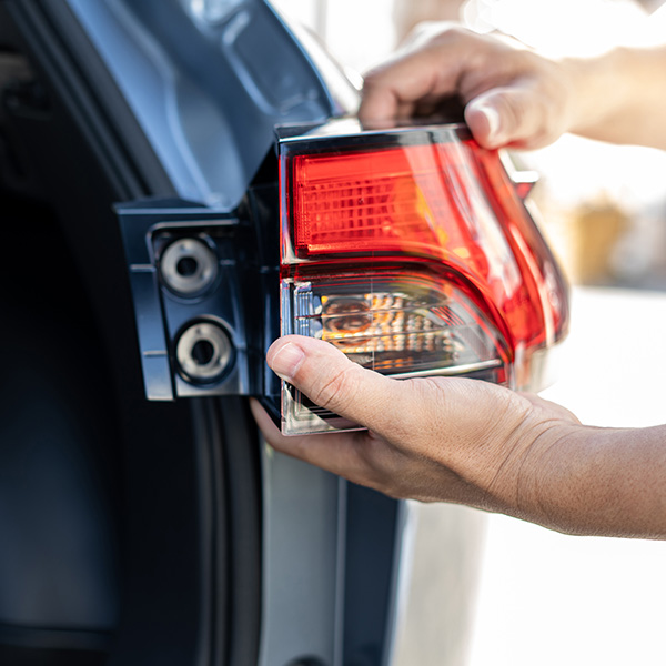Close up hand a man holding car tail lights