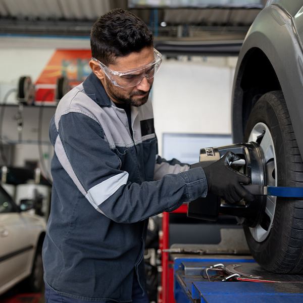 Mechanic balancing a tire at a car garage