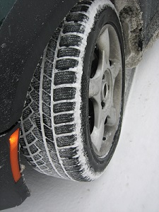 Close-up of a car tire with snow on tread